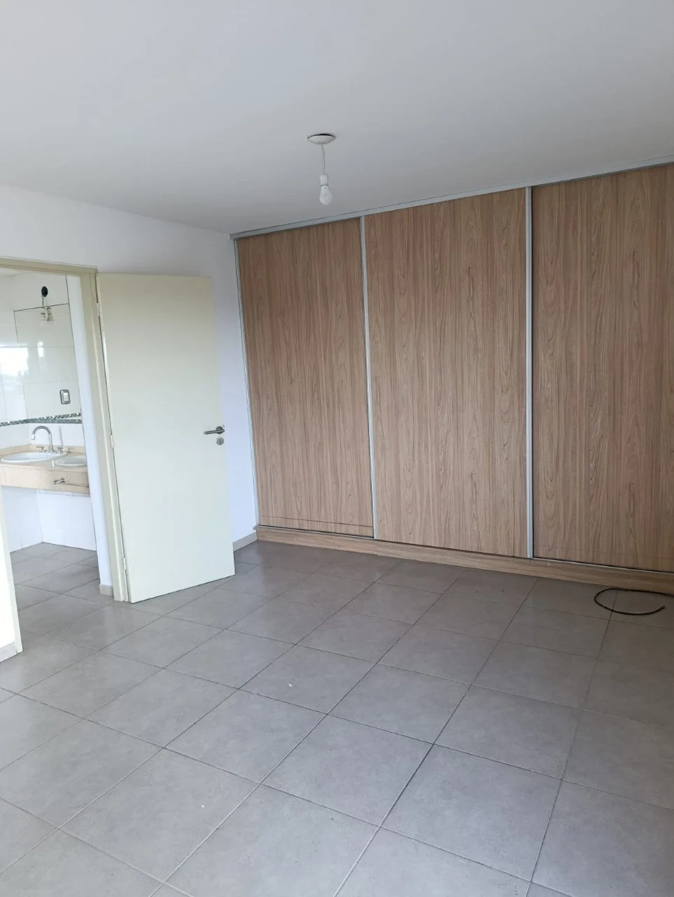 Dormitorio con placard de puertas corredizas.